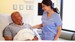 Nurse talking to man in hospital bed