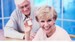 Portrait-of-senior-couple-seated-at-table-holding-pill-bottle-1024x576.jpg