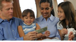 Happy-family-looking-at-money